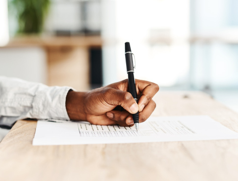 Man using pen to complete forms