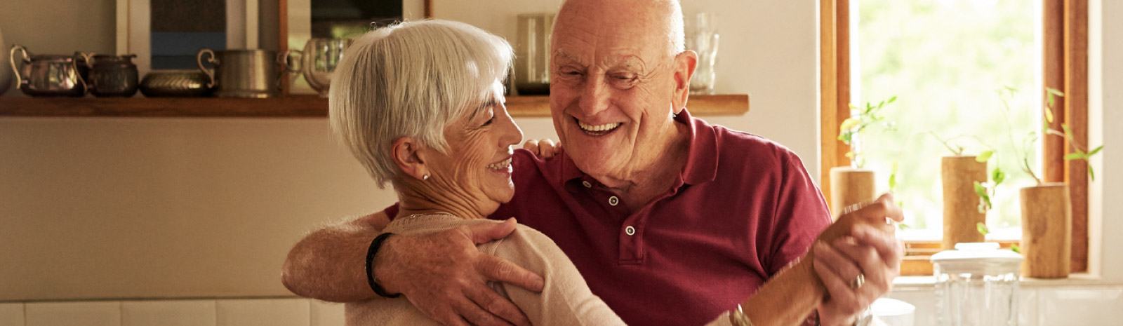 Mature couple dancing in kitchen