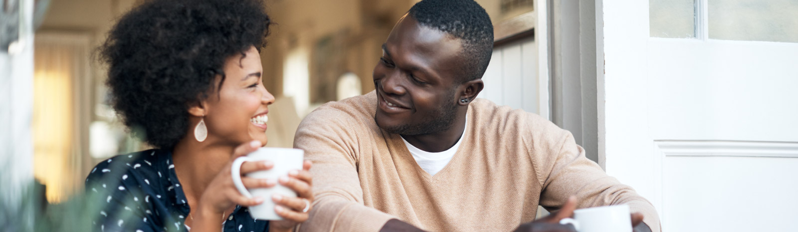 Couple sitting outside with coffee