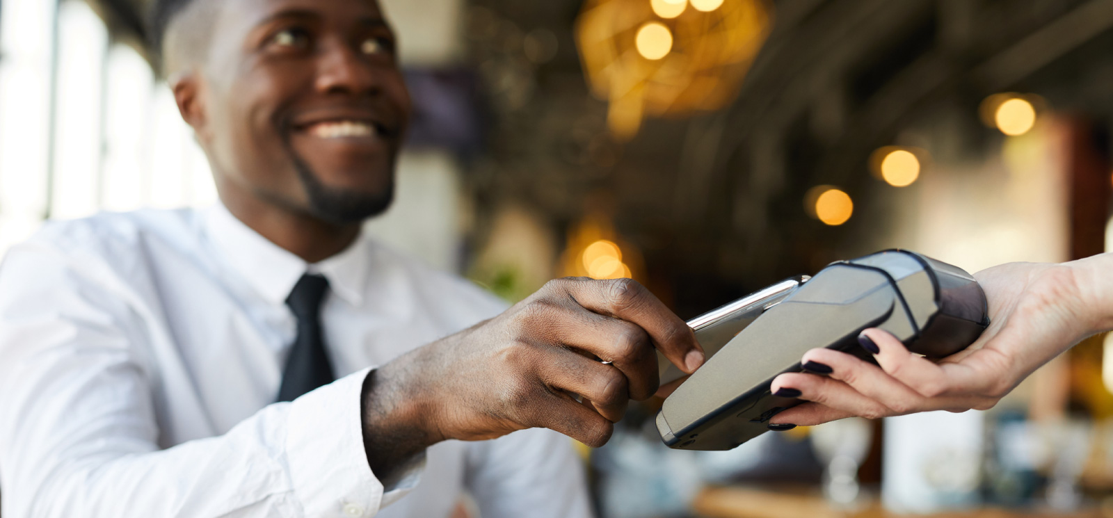 Man using mobile phone for contactless payment