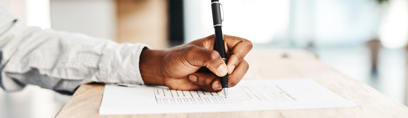 Man using pen to complete forms