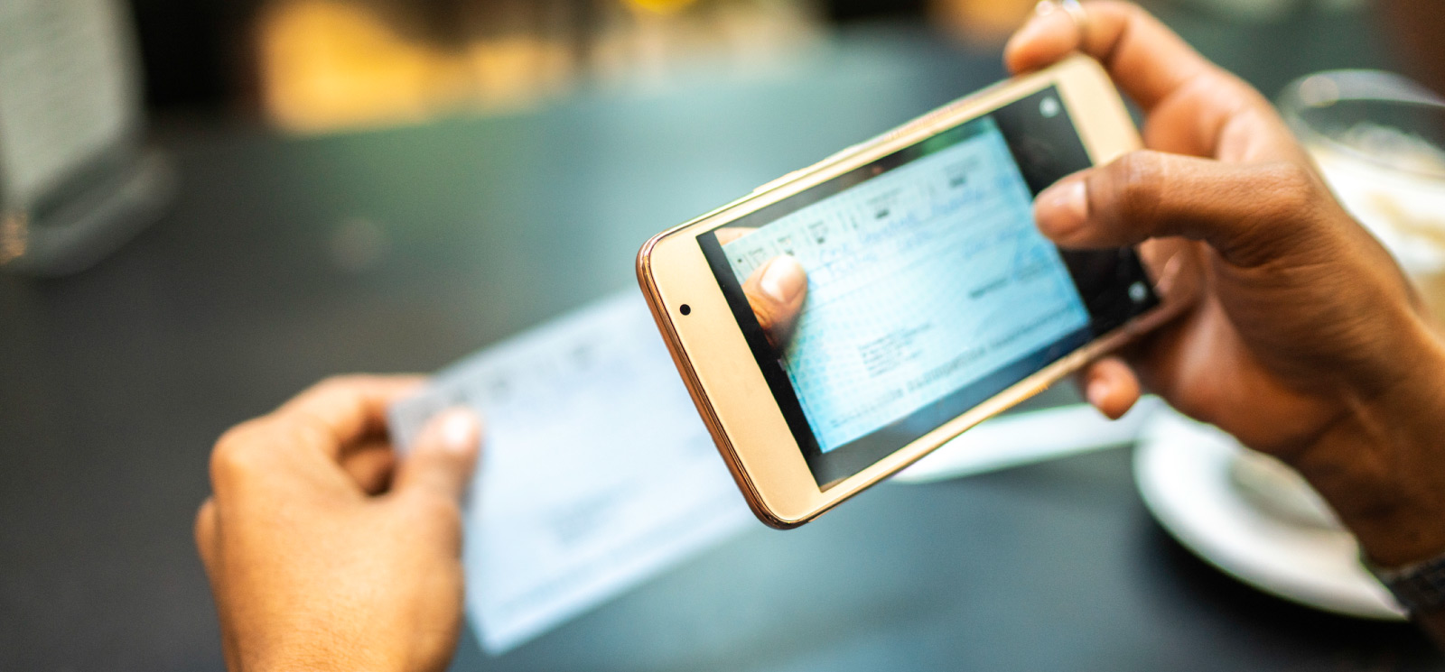 Woman using mobile phone to deposit check