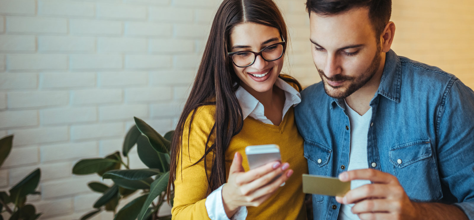 Couple with card and mobile phone in hand