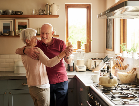 Mature couple dancing in kitchen