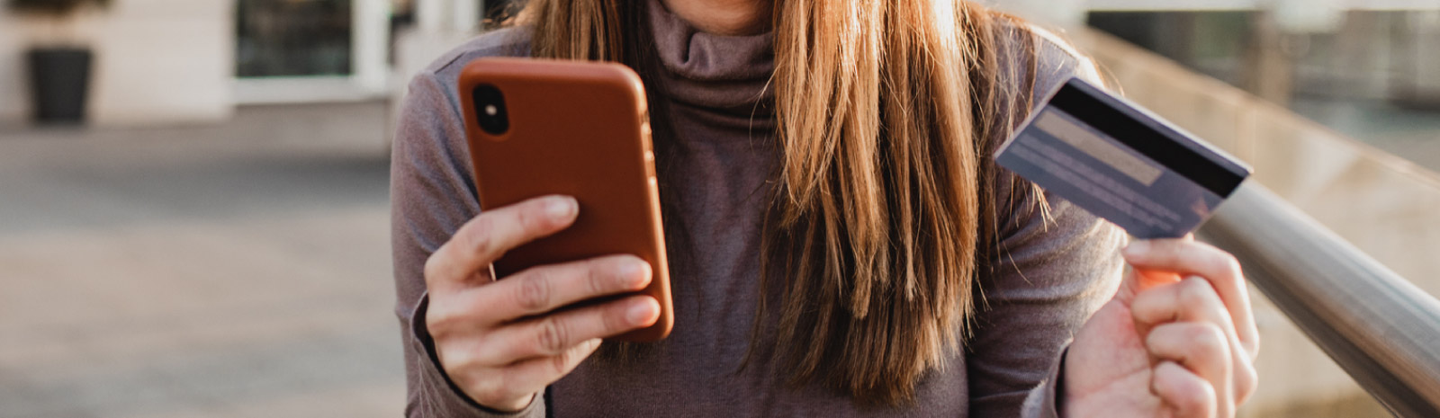 Woman holding phone and card